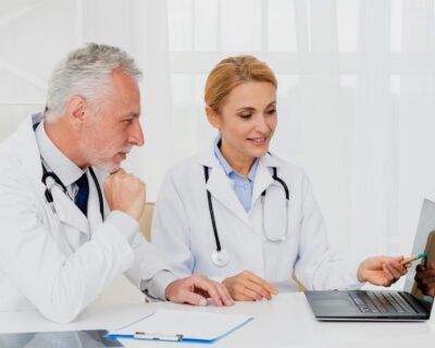 doctors-looking-laptop-while-sitting-1