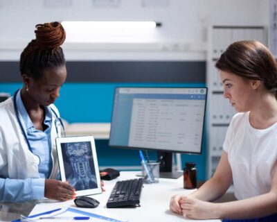 doctor-showing-cervical-vertebrae-injury-neck-pain-x-ray-ct-scan-results-tablet-patient-medical-appointment-healthcare-specialist-diagnosing-woman-after-symptoms-checkup-1