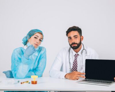 medical-team-posing-with-laptop-s-screen-1
