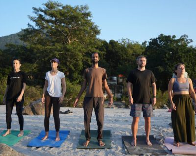 five-students-stand-tadasana-mats-sandy-ganga-riverbank-rishikesh2x